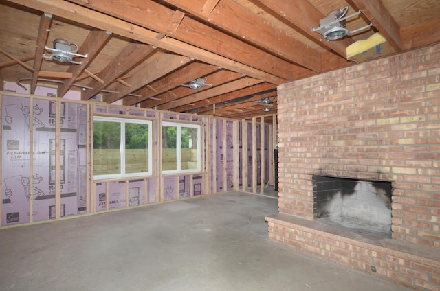 2603 140th Ln NW, Andover, MN 55304 - misc room with a brick fireplace and concrete floors