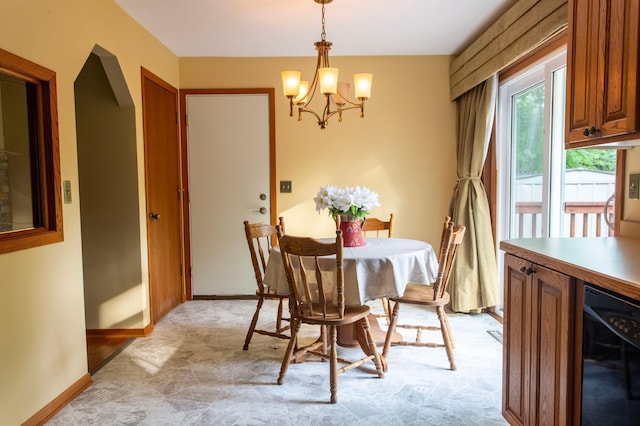 8659 215th St N, Forest Lake, MN 55025 - dining space featuring a chandelier, wine cooler, and baseboards