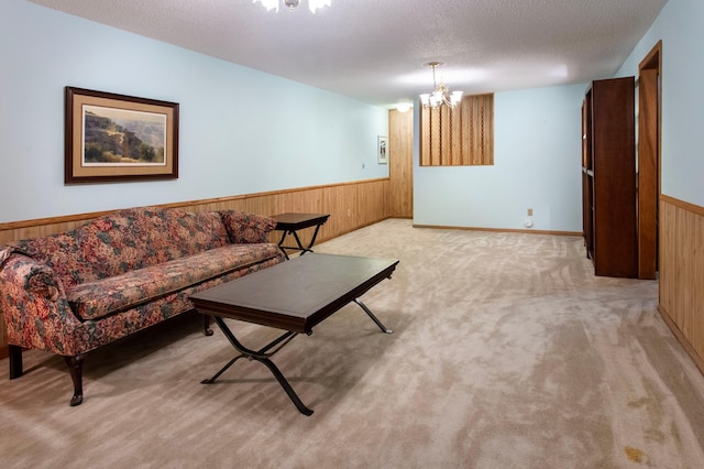 8659 215th St N, Forest Lake, MN 55025 - living room featuring wooden walls, wainscoting, light colored carpet, a chandelier, and a textured ceiling