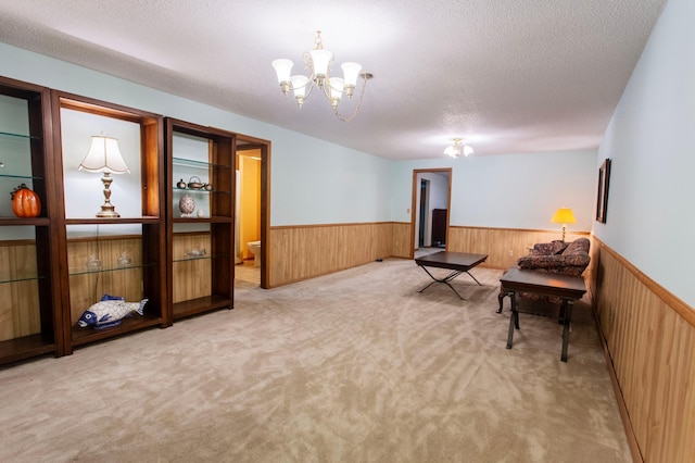 8659 215th St N, Forest Lake, MN 55025 - sitting room with a wainscoted wall, a chandelier, carpet flooring, wooden walls, and a textured ceiling