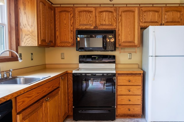 8659 215th St N, Forest Lake, MN 55025 - kitchen featuring black appliances, a sink, brown cabinets, and light countertops