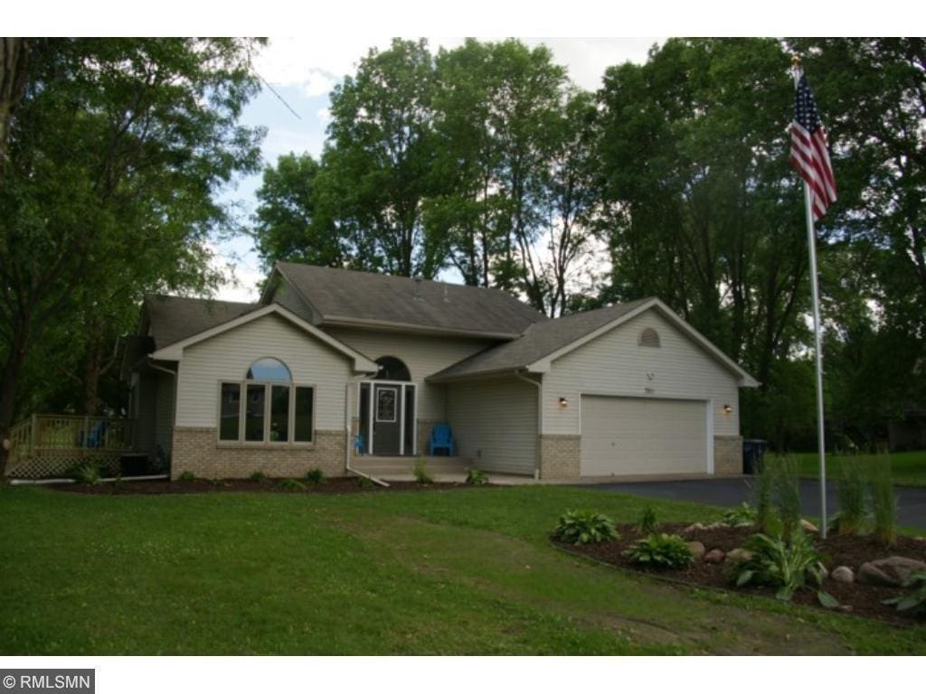 7811 209th St N, Forest Lake, MN 55025 - ranch-style home featuring an attached garage, brick siding, a front yard, and asphalt driveway