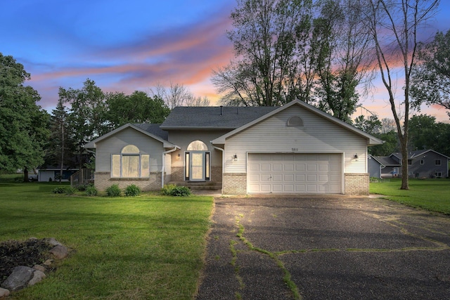 7811 209th St N, Forest Lake, MN 55025 - ranch-style house featuring brick siding, driveway, a garage, and a lawn