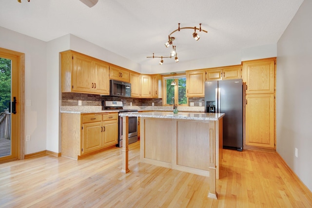 7811 209th St N, Forest Lake, MN 55025 - kitchen with stainless steel appliances, light wood-type flooring, tasteful backsplash, and a center island
