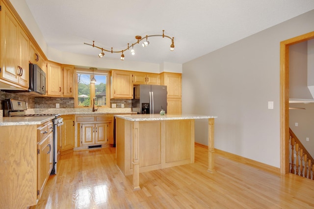 7811 209th St N, Forest Lake, MN 55025 - kitchen with stainless steel appliances, light wood finished floors, tasteful backsplash, a center island, and light brown cabinetry
