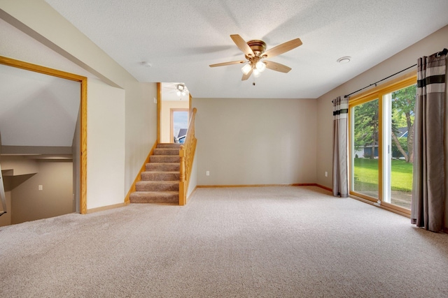 7811 209th St N, Forest Lake, MN 55025 - unfurnished living room featuring carpet floors, stairway, ceiling fan, and a textured ceiling