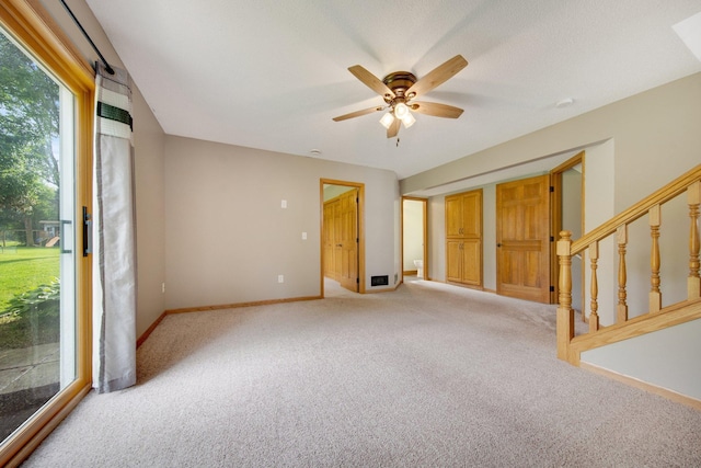 7811 209th St N, Forest Lake, MN 55025 - spare room featuring light colored carpet, ceiling fan, and stairs