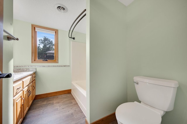 7811 209th St N, Forest Lake, MN 55025 - bathroom with wood finished floors, vanity, and tub / shower combination