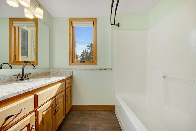 7811 209th St N, Forest Lake, MN 55025 - full bathroom featuring wood finished floors, vanity, and washtub / shower combination