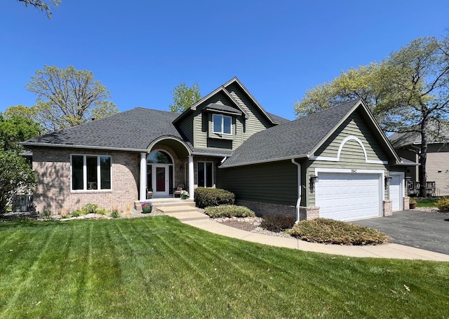 13542 Gossamer Way, Apple Valley, MN 55124 - traditional-style home featuring brick siding, a garage, a front lawn, driveway, and roof with shingles
