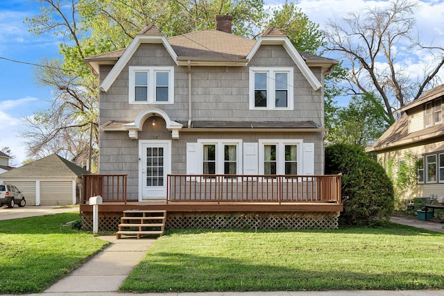 308 4th Ave SW, Austin, MN 55912 - view of front of property with a wooden deck, roof with shingles, a detached garage, a chimney, and a front yard