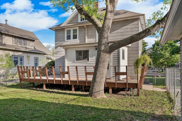 308 4th Ave SW, Austin, MN 55912 - rear view of house featuring a wooden deck and a chimney