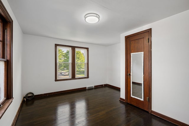 308 4th Ave SW, Austin, MN 55912 - unfurnished room with dark wood-style flooring and baseboards