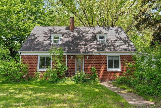 950 Clark St, Hammond, WI 54015 - new england style home with a chimney, a front yard, and brick siding