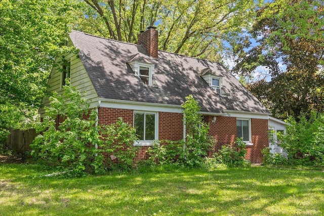 950 Clark St, Hammond, WI 54015 - rear view of property featuring brick siding, a chimney, and a yard