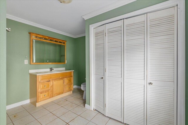 950 Clark St, Hammond, WI 54015 - bathroom with a closet, toilet, baseboards, vanity, and ornamental molding
