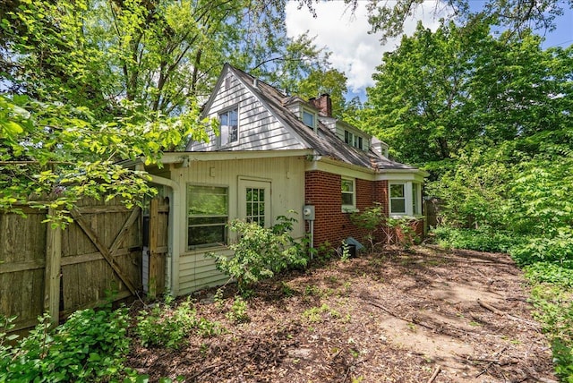 950 Clark St, Hammond, WI 54015 - view of side of property with a chimney, a gate, and brick siding