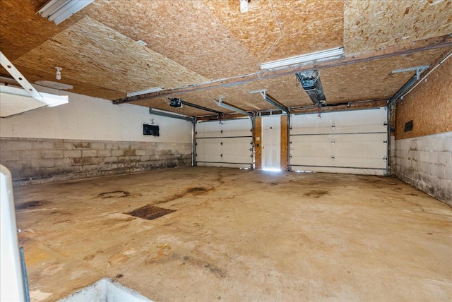 950 Clark St, Hammond, WI 54015 - garage featuring a garage door opener and concrete block wall
