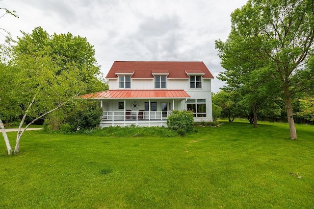 E2221 930th Ave, Stanton Twp, WI 54725 - back of house featuring covered porch, a lawn, a standing seam roof, and metal roof