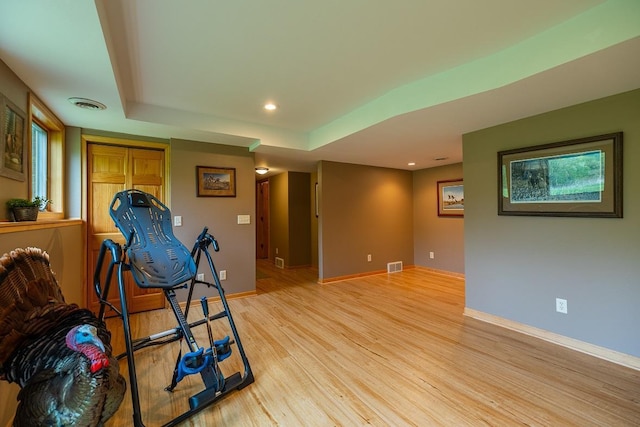 E2221 930th Ave, Stanton Twp, WI 54725 - exercise area with light wood-style floors, baseboards, recessed lighting, and a raised ceiling