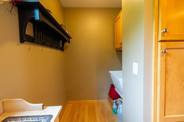 E2221 930th Ave, Stanton Twp, WI 54725 - laundry area with wood finished floors and baseboards