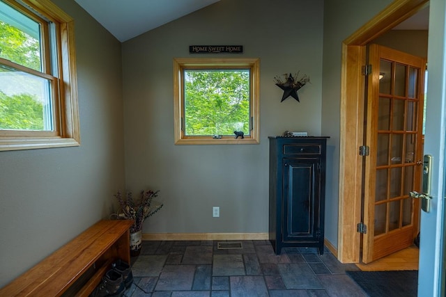 E2221 930th Ave, Stanton Twp, WI 54725 - entrance foyer featuring dark stone finish floors, lofted ceiling, and baseboards