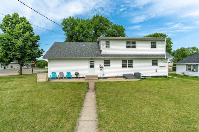727 Peck St, Fergus Falls, MN 56537 - back of house with a lawn, a shingled roof, entry steps, and a patio