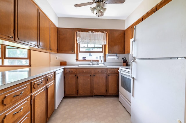 727 Peck St, Fergus Falls, MN 56537 - kitchen featuring white appliances, brown cabinetry, a ceiling fan, and light countertops