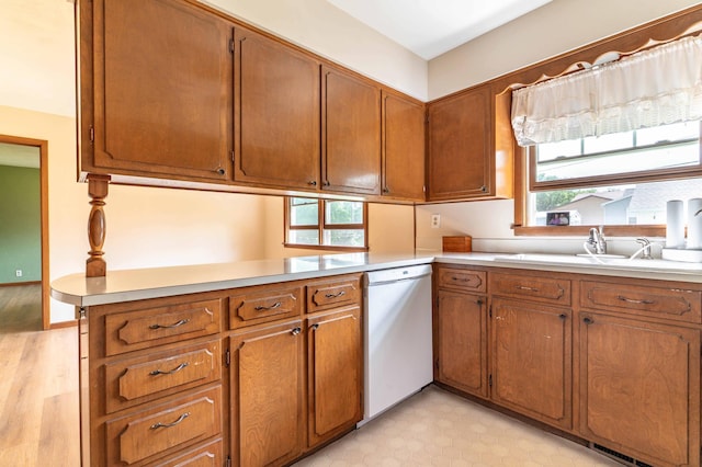 727 Peck St, Fergus Falls, MN 56537 - kitchen featuring dishwasher, light countertops, brown cabinets, and light wood finished floors