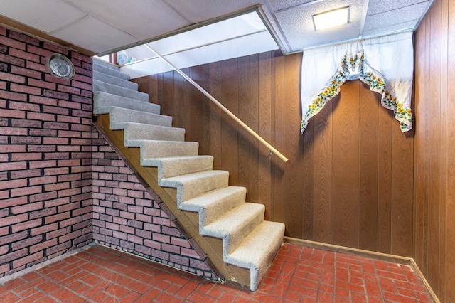 727 Peck St, Fergus Falls, MN 56537 - stairway with brick wall, wood walls, and brick floors