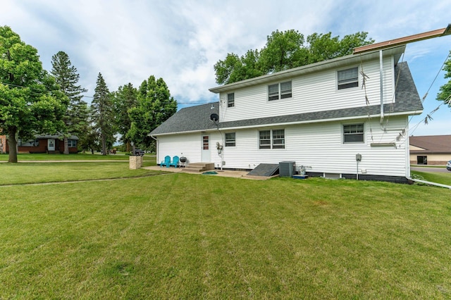 727 Peck St, Fergus Falls, MN 56537 - back of property with a yard, a shingled roof, and entry steps
