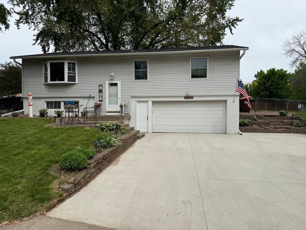 14496 55th St N, Oak Park Heights, MN 55082 - bi-level home featuring an attached garage and driveway