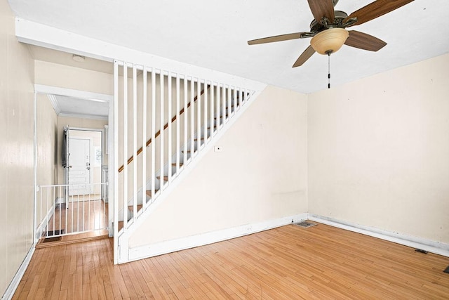 1040 86th Ave W, Duluth, MN 55808 - staircase featuring hardwood / wood-style flooring, baseboards, and a ceiling fan