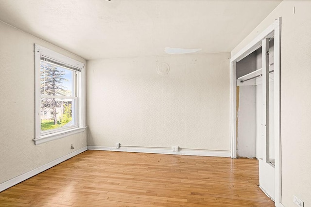 1040 86th Ave W, Duluth, MN 55808 - unfurnished bedroom with light wood-type flooring and baseboards