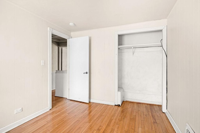 1040 86th Ave W, Duluth, MN 55808 - unfurnished bedroom featuring hardwood / wood-style flooring and a closet