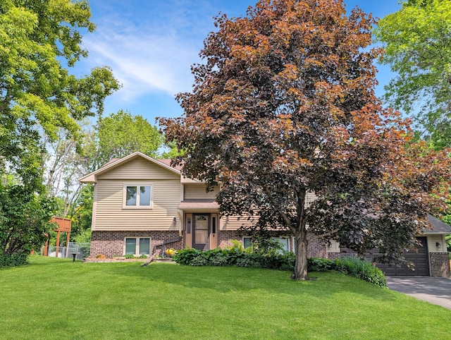 15142 75th Ave N, Maple Grove, MN 55311 - view of front of house with brick siding, a front lawn, and driveway