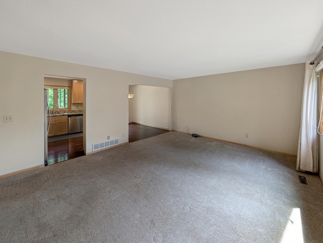 15142 75th Ave N, Maple Grove, MN 55311 - empty room with dark carpet, a sink, and baseboards