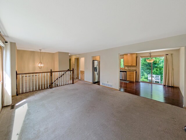 15142 75th Ave N, Maple Grove, MN 55311 - spare room featuring dark carpet and a chandelier