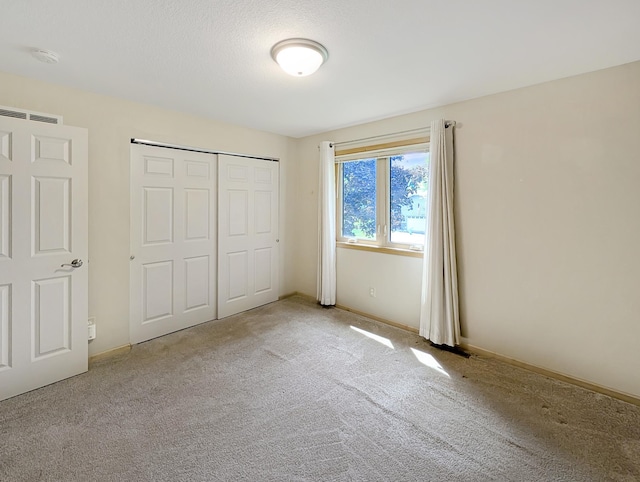 15142 75th Ave N, Maple Grove, MN 55311 - unfurnished bedroom with carpet flooring, a closet, and baseboards
