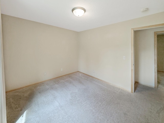15142 75th Ave N, Maple Grove, MN 55311 - spare room featuring carpet floors, baseboards, and a smoke detector