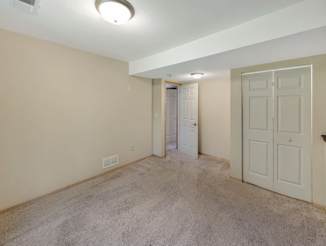 15142 75th Ave N, Maple Grove, MN 55311 - unfurnished bedroom with carpet, baseboards, a textured ceiling, and a closet