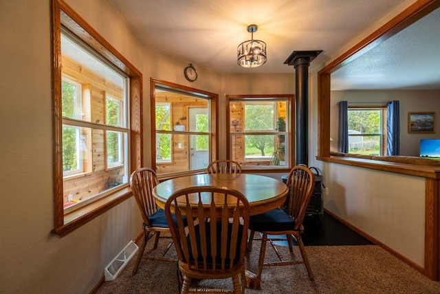 S363 Nicholes Rd, Naples Twp, WI 54755 - carpeted dining room featuring a chandelier and baseboards