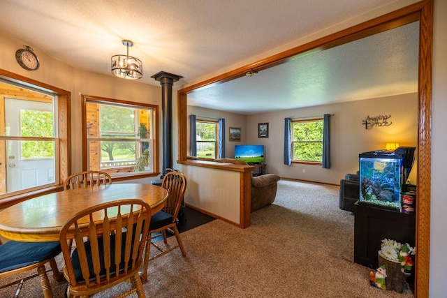 S363 Nicholes Rd, Naples Twp, WI 54755 - carpeted dining room with plenty of natural light, a chandelier, and baseboards
