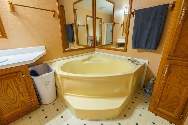 S363 Nicholes Rd, Naples Twp, WI 54755 - bathroom featuring a garden tub and vanity
