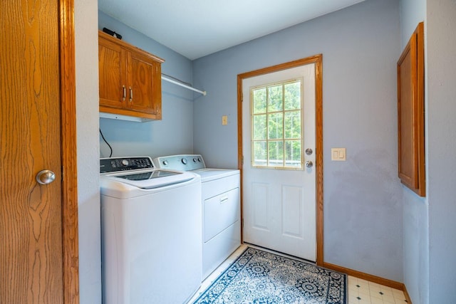 S363 Nicholes Rd, Naples Twp, WI 54755 - laundry room with washing machine and dryer, cabinet space, baseboards, and light flooring