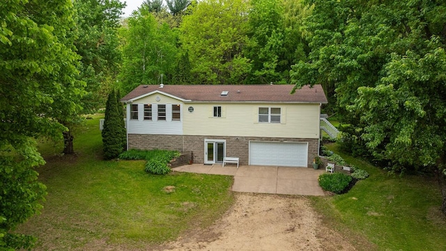 S363 Nicholes Rd, Naples Twp, WI 54755 - view of front of house with concrete driveway, an attached garage, a front lawn, a patio area, and brick siding