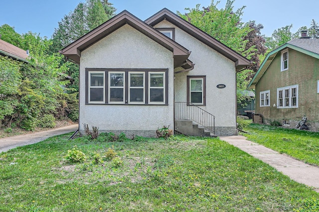 2653 Pierce St NE, Minneapolis, MN 55418 - bungalow featuring stucco siding and a front lawn