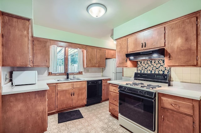 2653 Pierce St NE, Minneapolis, MN 55418 - kitchen with gas stove, under cabinet range hood, black dishwasher, a sink, and light flooring