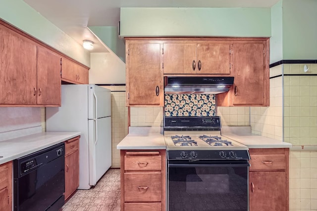 2653 Pierce St NE, Minneapolis, MN 55418 - kitchen with range with gas cooktop, under cabinet range hood, dishwasher, light countertops, and freestanding refrigerator