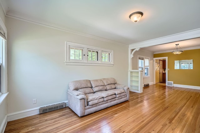 2653 Pierce St NE, Minneapolis, MN 55418 - living room with ornamental molding, light wood finished floors, and baseboards